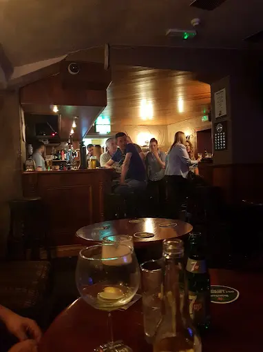 Customers chatting at the bar on a busy evening