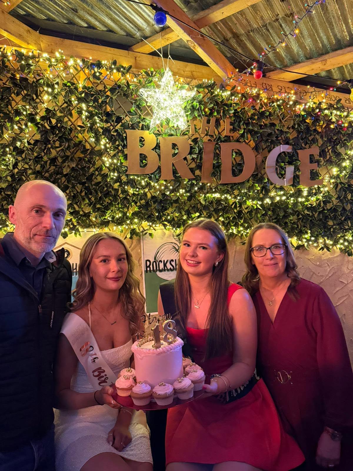 Friends gathered around a decorated party table
